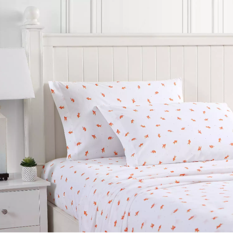 A patterned sheet set on a bed.