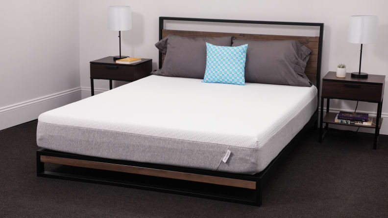 The Tuft and Needle mattress appear in a bedroom with bedside tables on either side.
