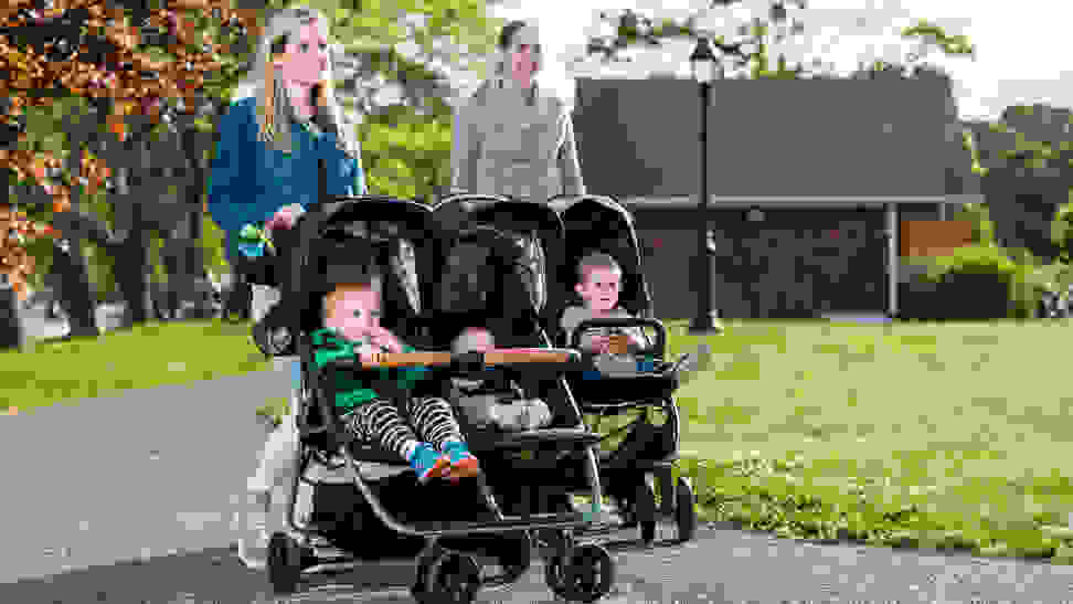 Two moms walking with double strollers