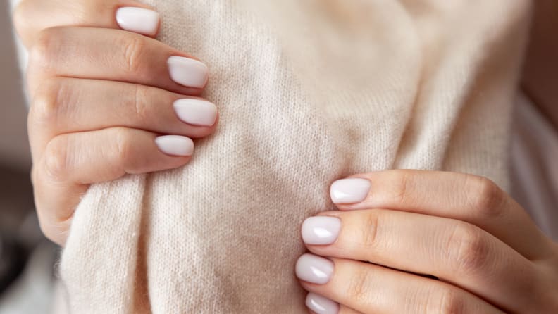 A close-up of someone holding cashmere fabric.