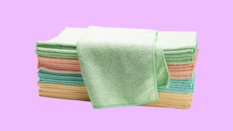 A set of colorful dish rags on a purple background.