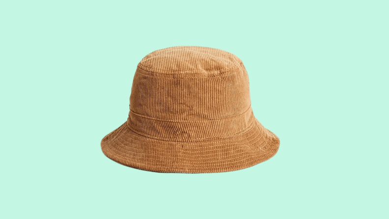 A brown corduroy hat against a green background.