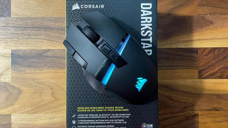 A bird's eye view of the Corsair Darkstar Wirless mouse on top of the product box.