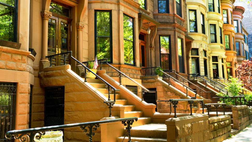 Brownstone apartments with stoops in front.