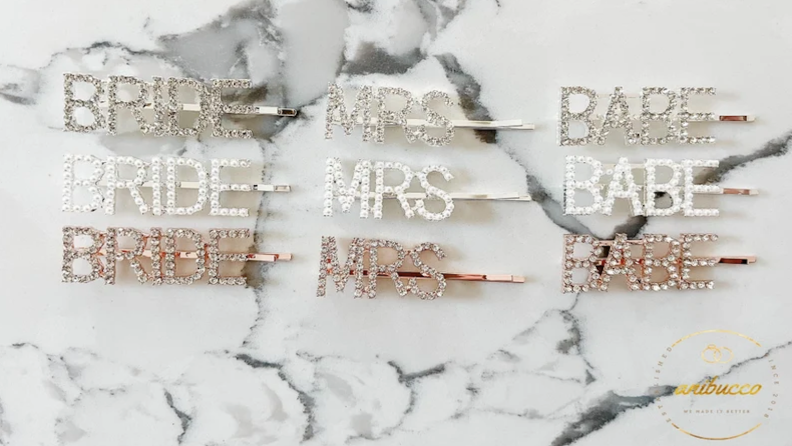 Gold, silver and pearl hair pins that read, "Bride."
