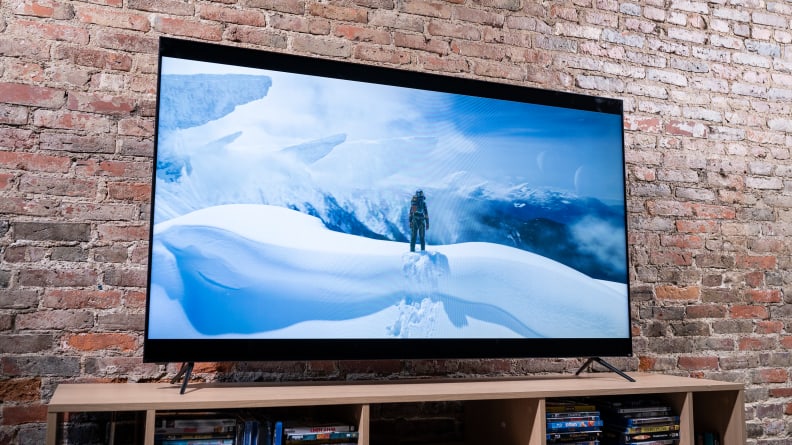 On a Vizio TV screen, a fictional astronaut climbs a snowy mountain on an alien world.