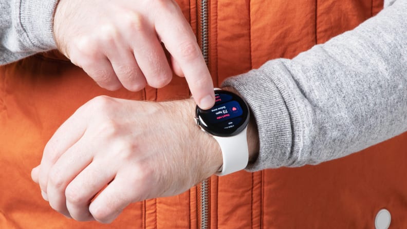 A Man showing the correct placement of a smartwatch, on his wrist.