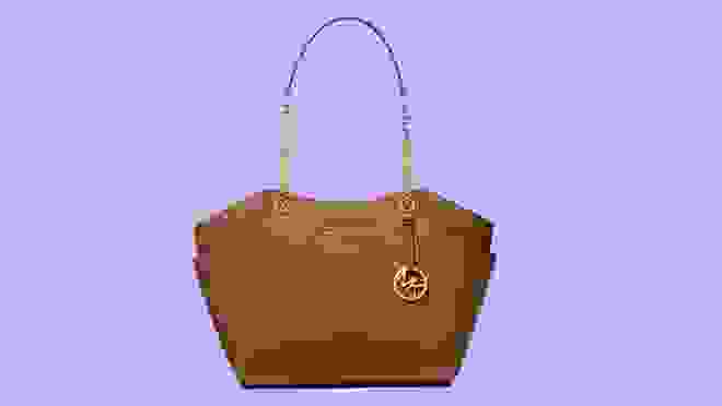 Brown leather bag against purple background