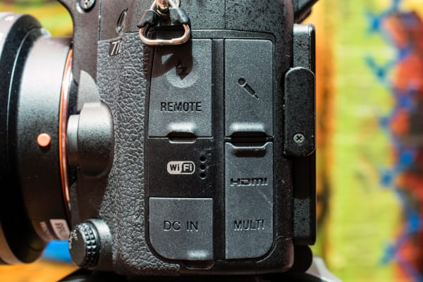 The A77II offers many ports including DC IN, HDMI, USB, and a mic jack.