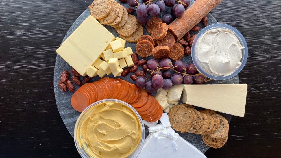 A photo of a vegan cheese board, on a marble slab, shot from above