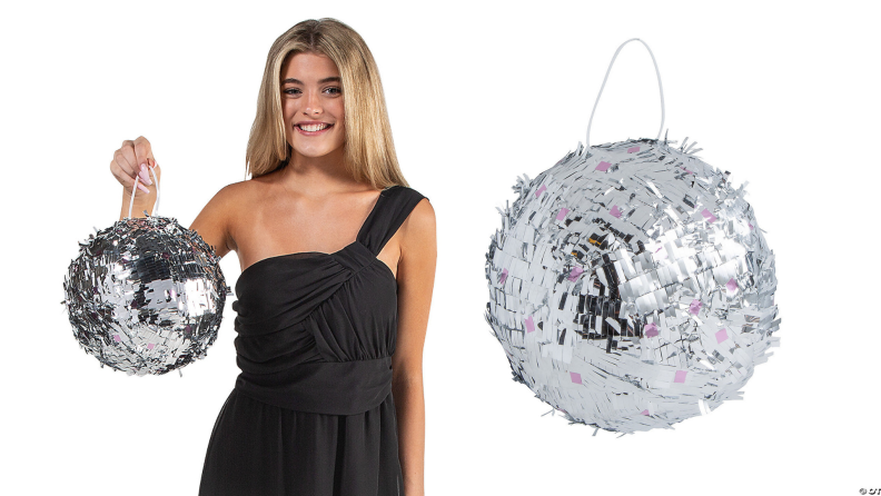 On left, person wearing black dress while holding silver disco ball. On right, silver disco ball.