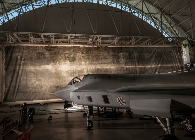 The Great Picture hangs behind a fighter jet in the Smithsonian