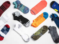 An array of unisex running socks from brands like Nike, Puma, and Saucony.