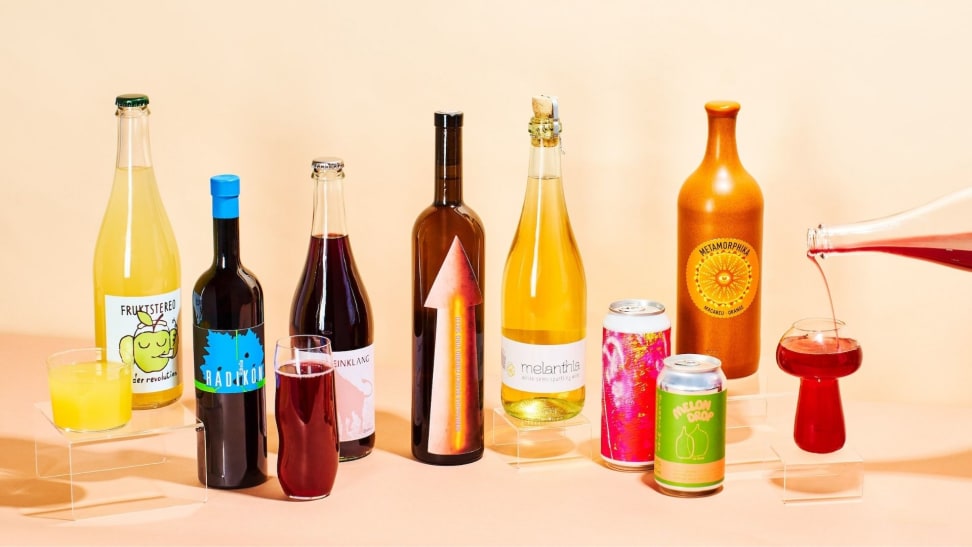 Assorted bottles and cans of various natural wine varietals, featuring brightly-colored labels.