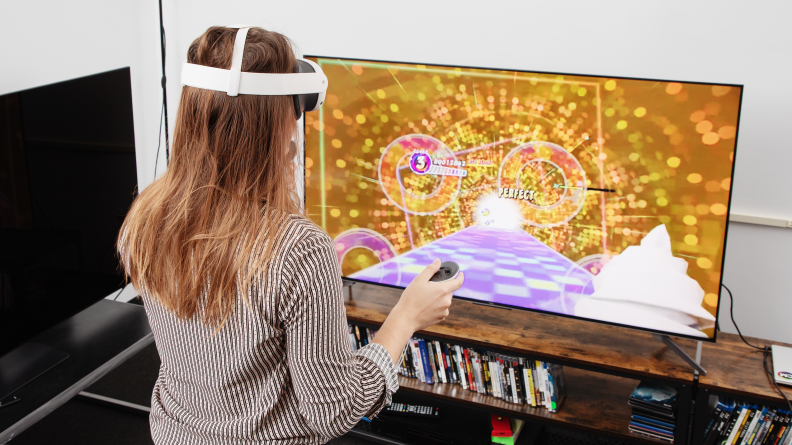 a woman looking at a tv with a vr headset on