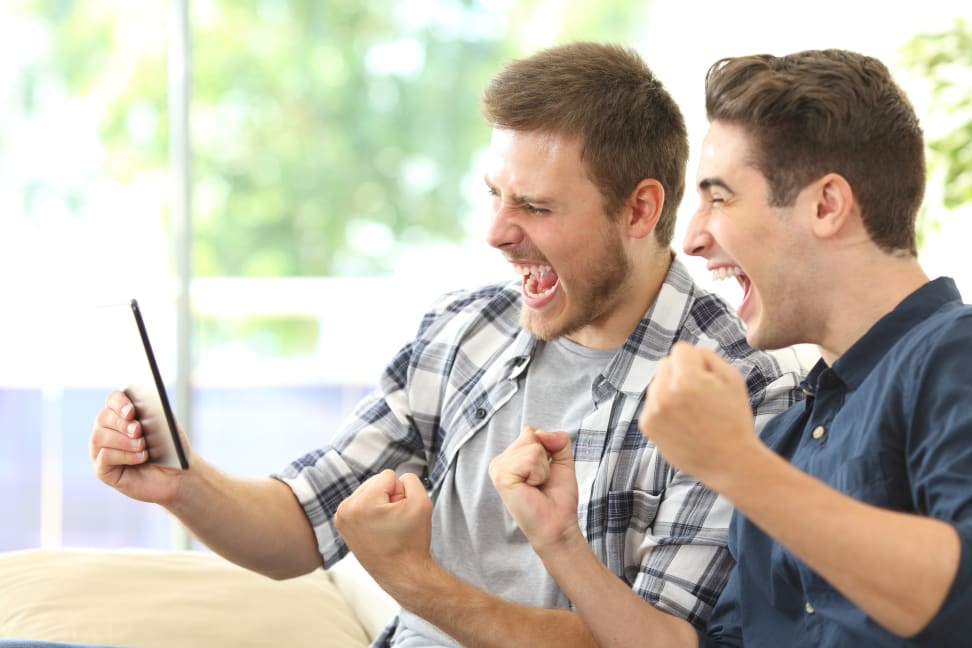 Two men watching TV on a tablet