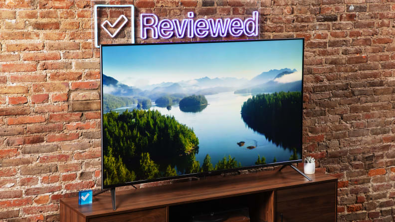 The Amazon Fire TV Omni on a wooden table displaying a river winding through a forest.