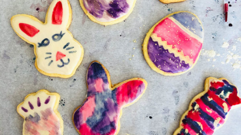 Colorful cookies lying on a parchment paper pan