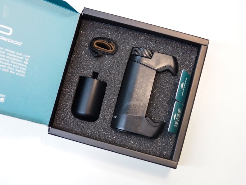 Inside, the two-part grip and strap are carefully packaged.