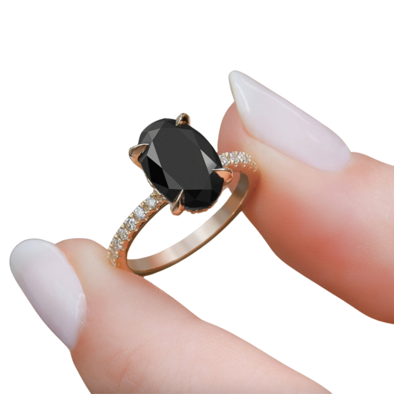 Person holding a 14k Black Oval Cut Diamond Ring from DianaBlackIce in their fingers.