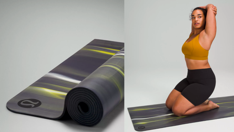 A person sits on a black yoga mat.