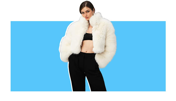 A model wearing a white faux fur jacket.