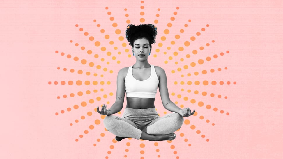 A woman practicing yoga in lotus pose.