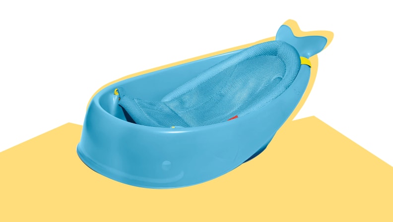 The Skip Hop Moby whale-shaped baby bath tub on a white and yellow background.