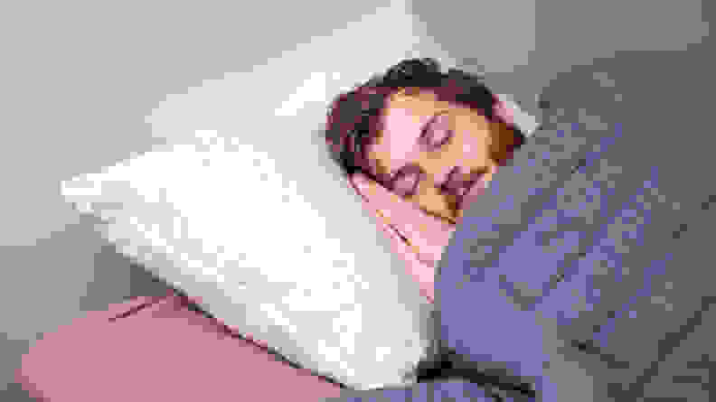 a man sleeps on the Coop Home Goods Original Pillow