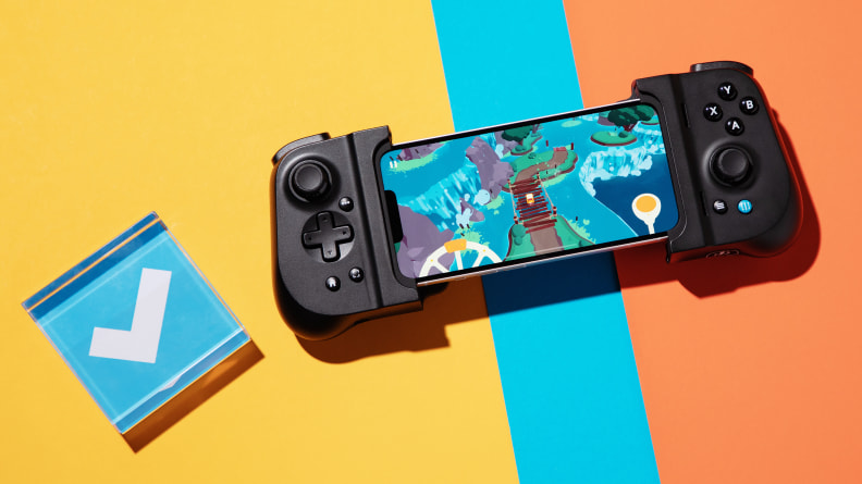 A mobile gaming handheld wrapped around a phone with a colored background and a blue checkmark on the left side