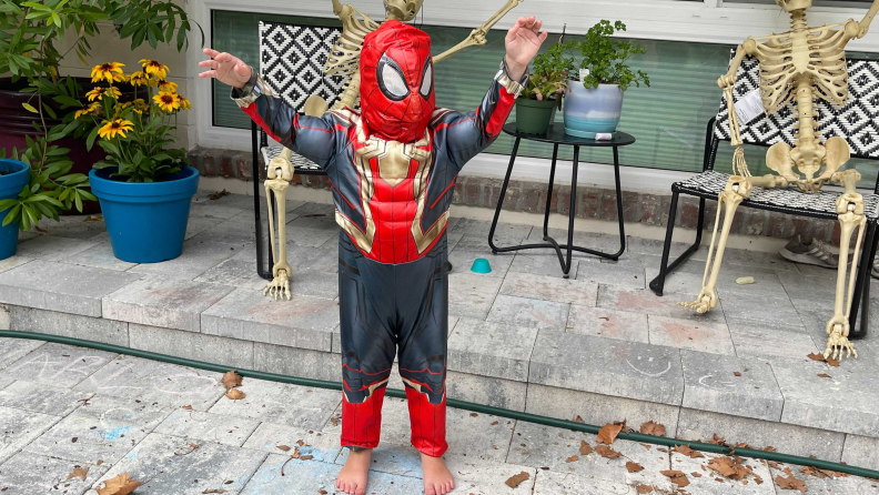 A small child dressed in a Spider-Man costume