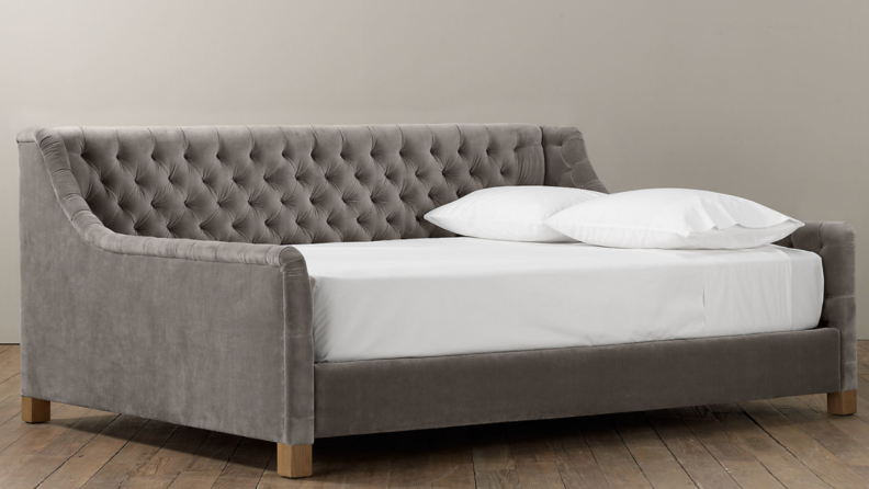 Product shot of gray tufted daybed.