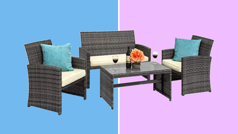 An image of a set of dark wicker patio furniture with two chairs, a loveseat, and a glass-topped table. The chairs and loveseat all have cream colored cushions on the seats, with blue throw pillows on the chairs.