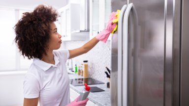 Woman cleaning her fridge