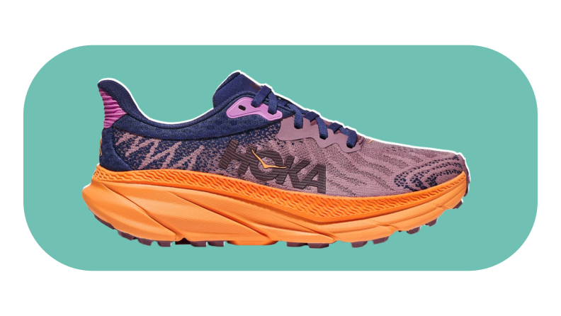The Hoka Arahi 6 shoe in the color purple and orange on a teal background.
