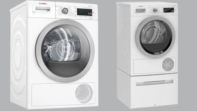 匹配的洗衣机和烘干机设置从博世前面的灰色背景。