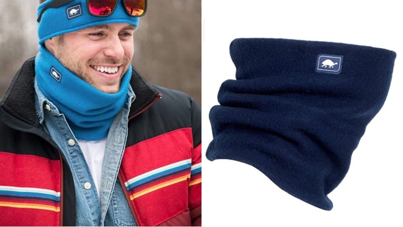 A hiker wears a blue neck gaiter to keep snow and other precipitation from getting into their shirt and neckline area.