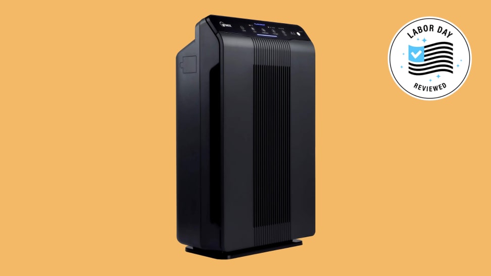 A black Winix air purifier on a yellow background with a Labor Day badge.
