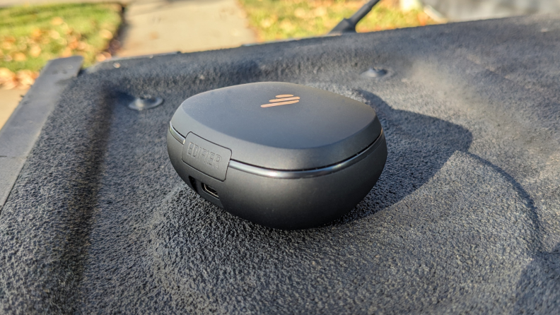 The case for the Edifier NeoBuds Pro 2 in an outdoor setting.