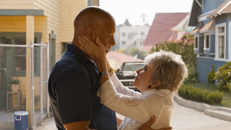 An image of Vin Diesel as Dom in 'Fast X' getting spoken to and embraced by Rita Moreno as Abuelita Toretto.