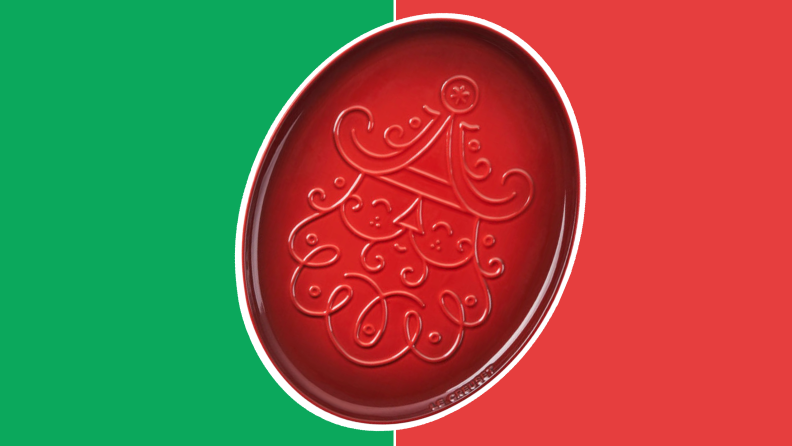 Red cast-iron plate with embossed Santa design on front in front of red and green collage.