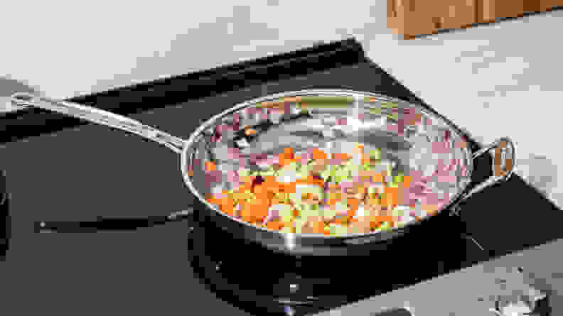 The Cuisinart Chef's Classic Stainless Steel skillet is filled with vegetables.