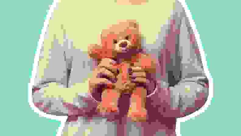 Person holding brown teddy bear.