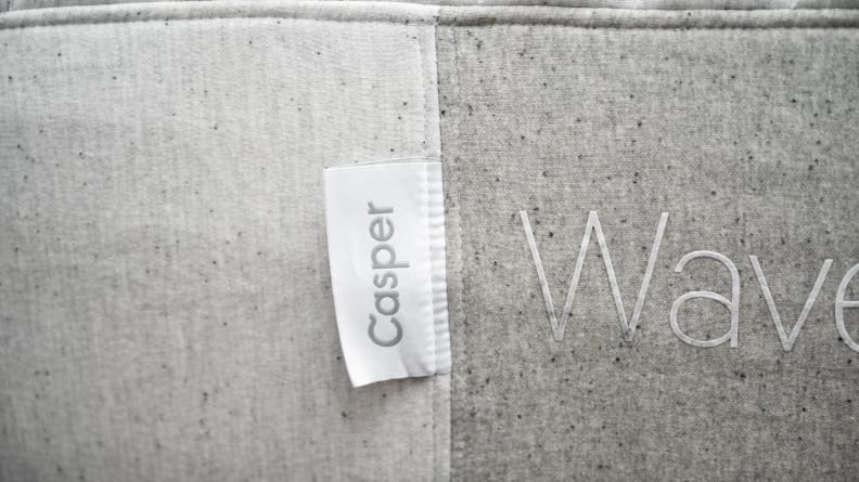 Side of a mattress with the Casper logo tag zoomed in