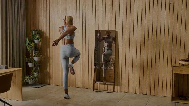 Person exercising in front of lululemon's The Mirror