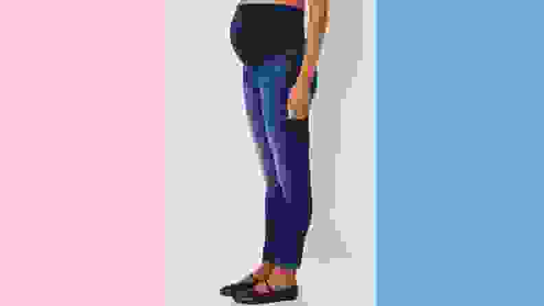 A pregnant woman wearing jeans from A Pea in the Pod.