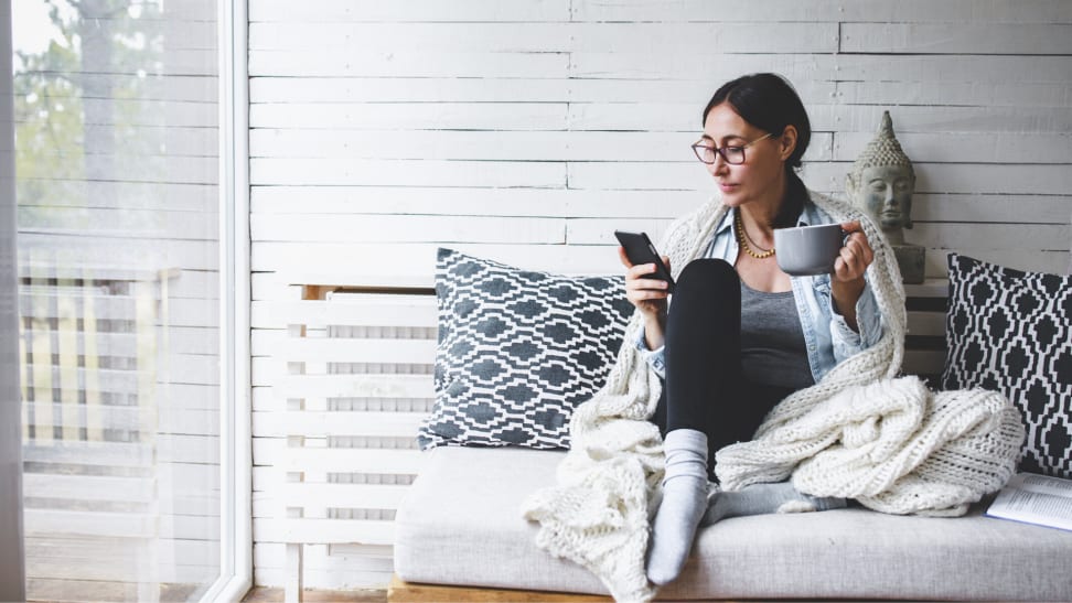 woman relaxing on a couch with a cup of tea