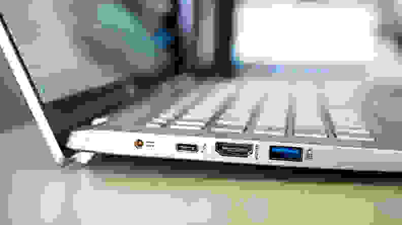 A close up of connectivity ports on the side of a silver laptop.