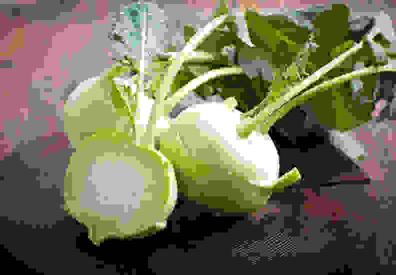 Fresh kohlrabi on the wooden table closeup.