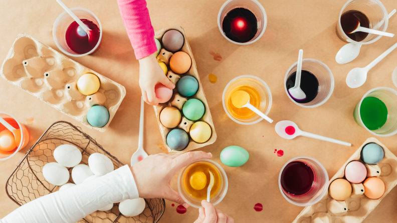 Kids decorating easter eggs on a table